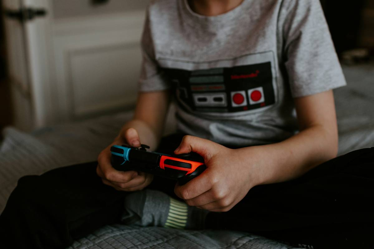 kids using a gaming bed for kids with organized storage and dual monitors