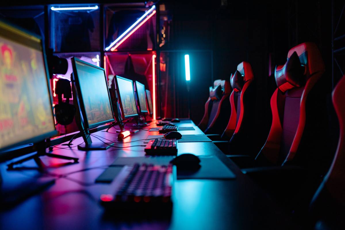 gaming room bed room setup with loft bed, dual monitors, and under-bed storage